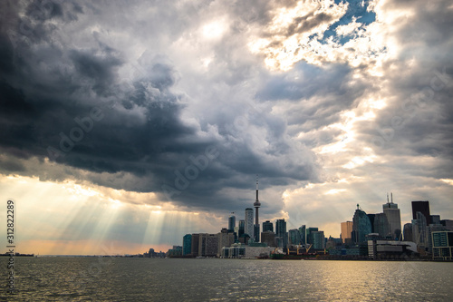 A high-contrast view of the Toronto skyline with a dramatic sky covered in clouds, Toronto, Ontario, Canada