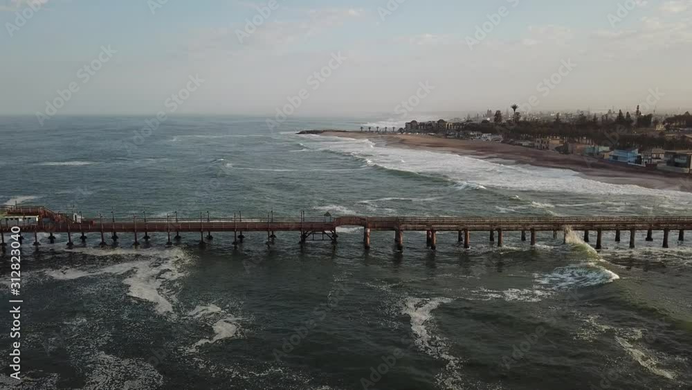 4K aerial drone video of Namibian Atlantic coastline, Swakopmund vintage buildings, town panorama, beach, old Jetty pier, landscape with ocean background of holiday resort at Namibia's west coast 4K aerial drone video of Namibian Atlantic coastline, Swakopmund vintage buildings, town panorama, beach, old Jetty pier, landscape with ocean background of holiday resort at Namibia's west coast