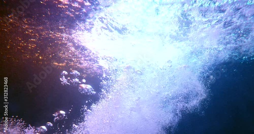 Slow motion plunging girl to fall under water into pool in the dark photo