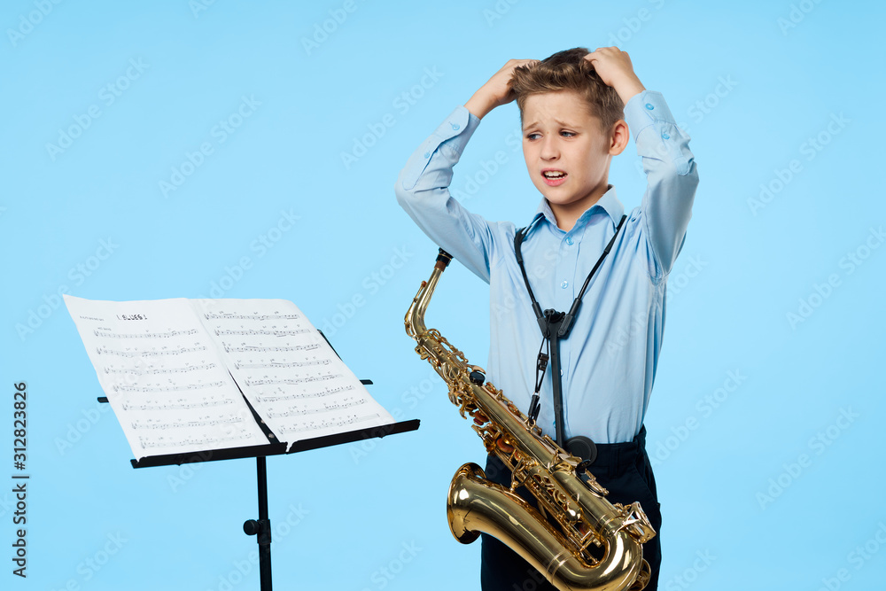 Fototapeta premium young boy with a saxophone