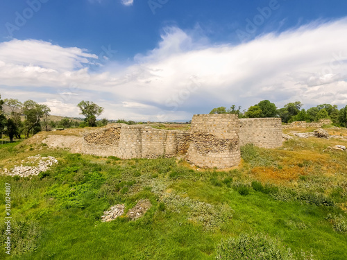 The ruins of the tower of the fortress. Stone wall bastion. Ruined castle. Saint Nino Street, Rustavi, Georgia. photo