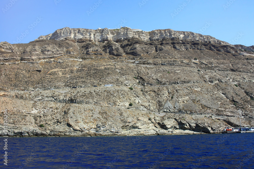 The coast of the Greek island of Santorini with the cliff towns of Oia and Thira