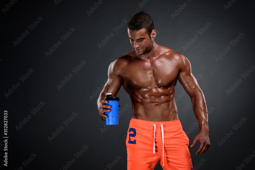 Nutritional Supplement. Muscular Men Drinks Protein, Energy Drink After Workout. Copy Space Nutritional Supplement. Muscular Men Drinks Protein, Energy Drink After Workout. Copy Space