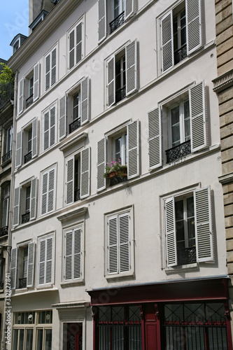 Paris, modern apartment building with louvered shutters on windows to keep out the sun © Spiroview Inc.