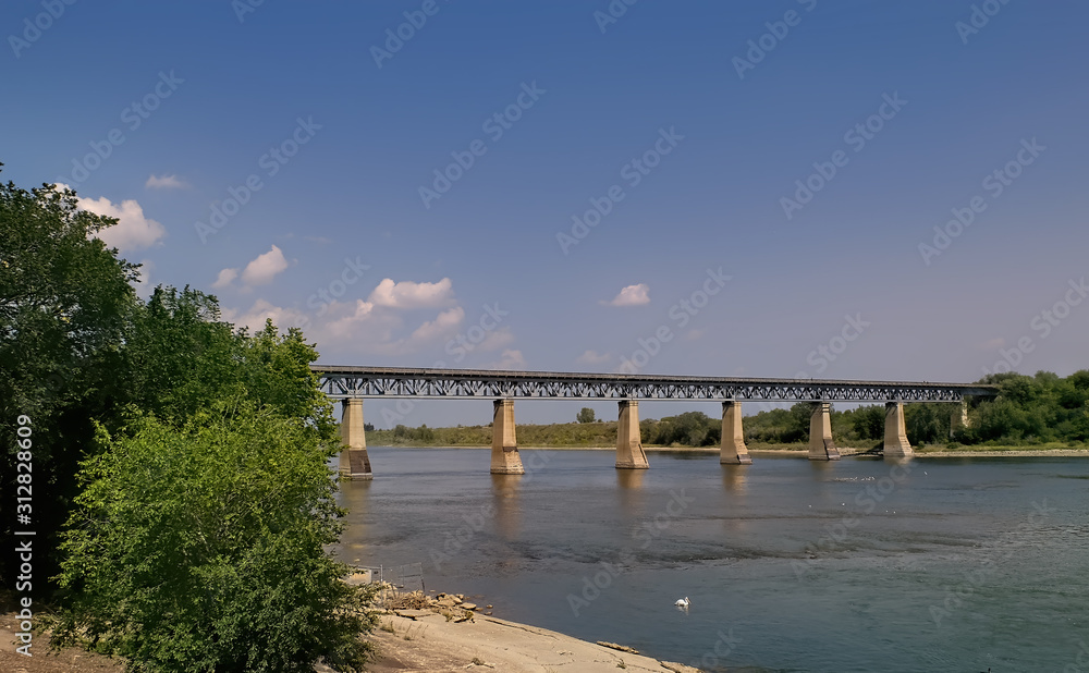 CN railway bridge over the South Saskatchewan River in a sunny summer day in Saskatoon Saskatchewan Canada