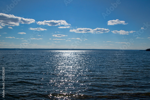 Sunset glinting off gentle waves on Waskesiu Lake in Prince Albert National Park in Saskatchewan Canada photo