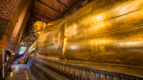 Golden Statue of the Reclining Buddha at Wat Pho Buddhist Temple Complex in the Phra Nakhon District, Bangkok, Thailand. Religious Monument, Tourist Attraction, Travel Destination Concepts.