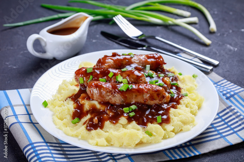 Bangers and Mash with Onion Gravy on a plate