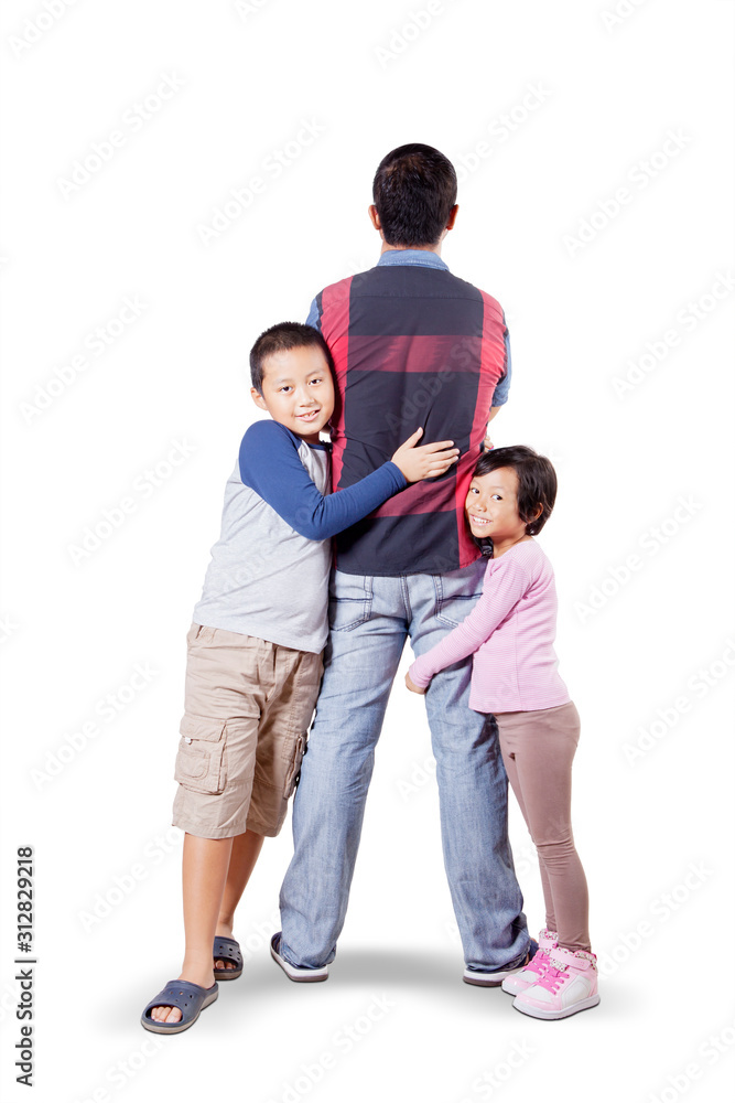 Man doing back pose while his children hugging him Man doing back pose while his children hugging him