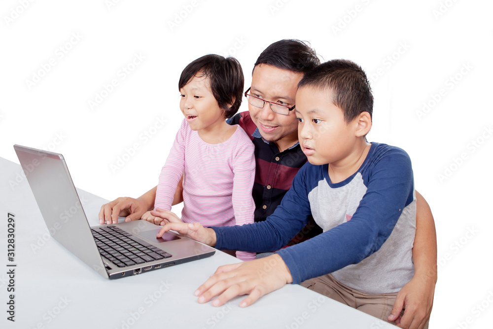 Man teaching his children how to use a computer Man teaching his children how to use a computer
