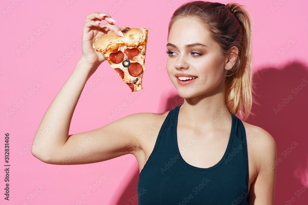 The cheerful woman holds pizza in hands