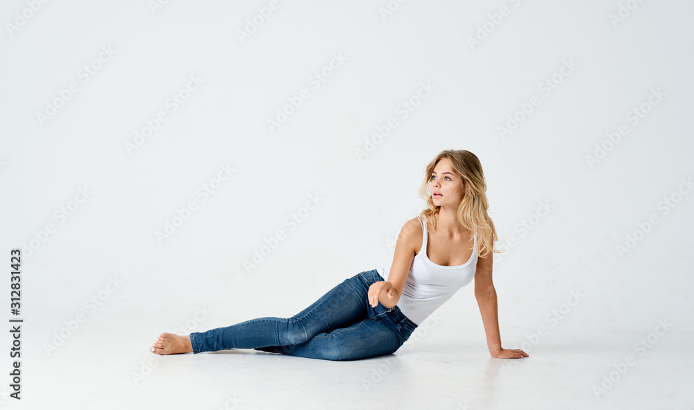 young woman sitting on the floor isolated on white
