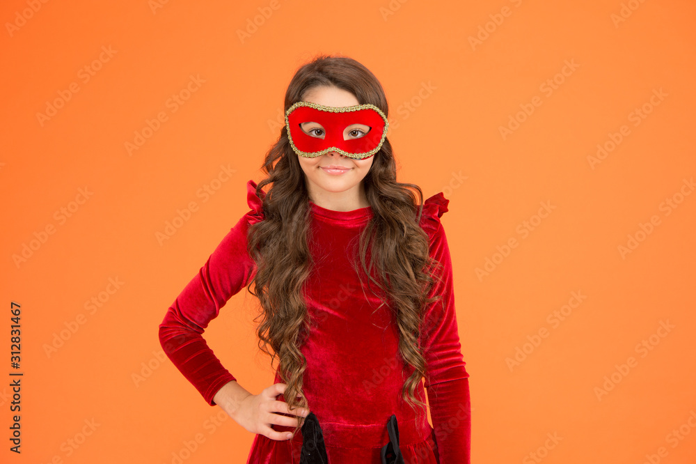 Visit public event anonymously. Winter new year party. Winter carnival. Masquerade concept. Kid wear eye mask. Girl wear mask orange background. Winter event and entertainment. Child development Visit public event anonymously. Winter new year party. Winter carnival. Masquerade concept. Kid wear eye mask. Girl wear mask orange background. Winter event and entertainment. Child development