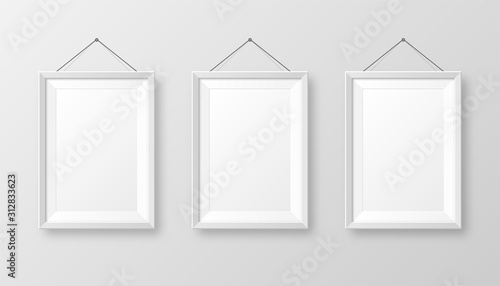 Realistic hanging on a wall blank white picture frame with shadow. Modern poster mockup isolated on gray background. Empty photo frame for art gallery or interior. Vector illustration.