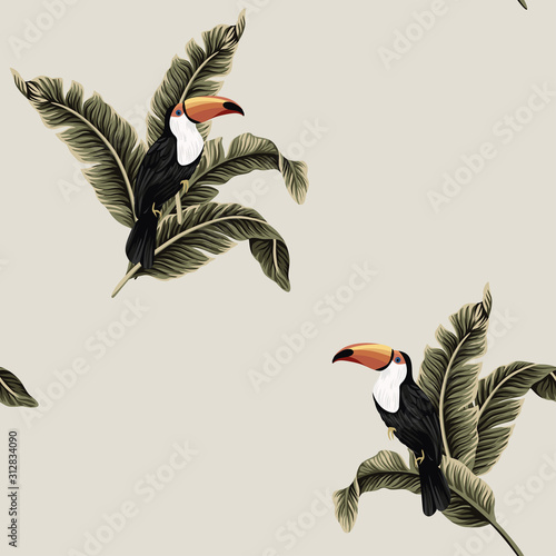 Tropical vintage exotic bird toucan, banana leaves floral seamless pattern beige background. Exotic jungle wallpaper.