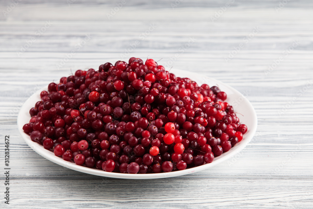 Photo of a plate topped with cranberries. Copy space. Photo of a plate topped with cranberries. Copy space.