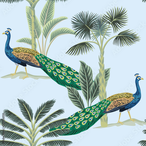 Tropical vintage peacock bird, palm tree and plant floral seamless pattern blue background. Exotic jungle wallpaper.