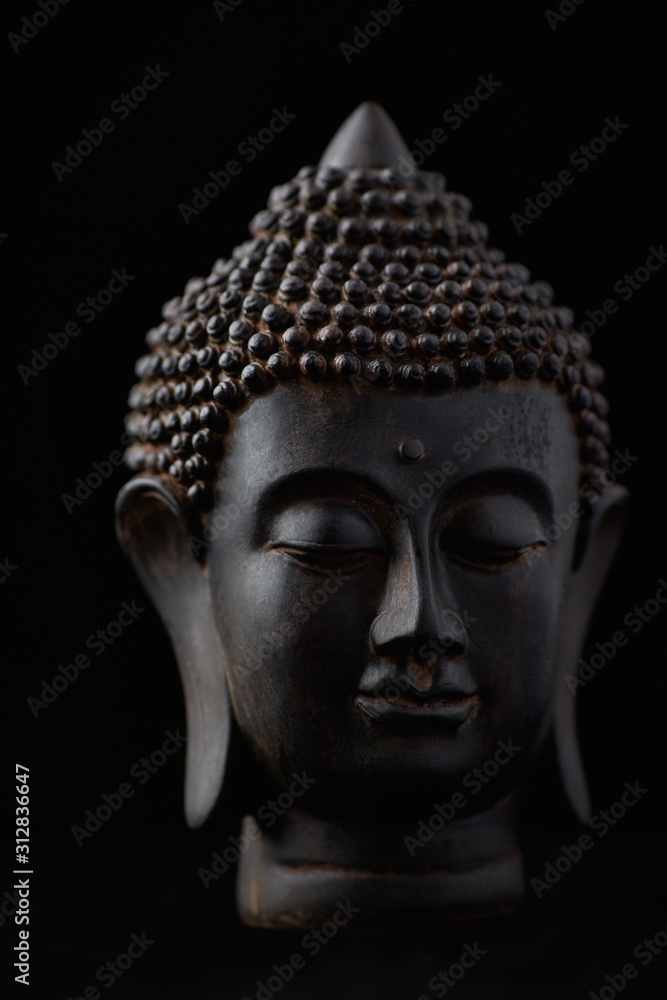 Buddha Statue (close-up). Black background.