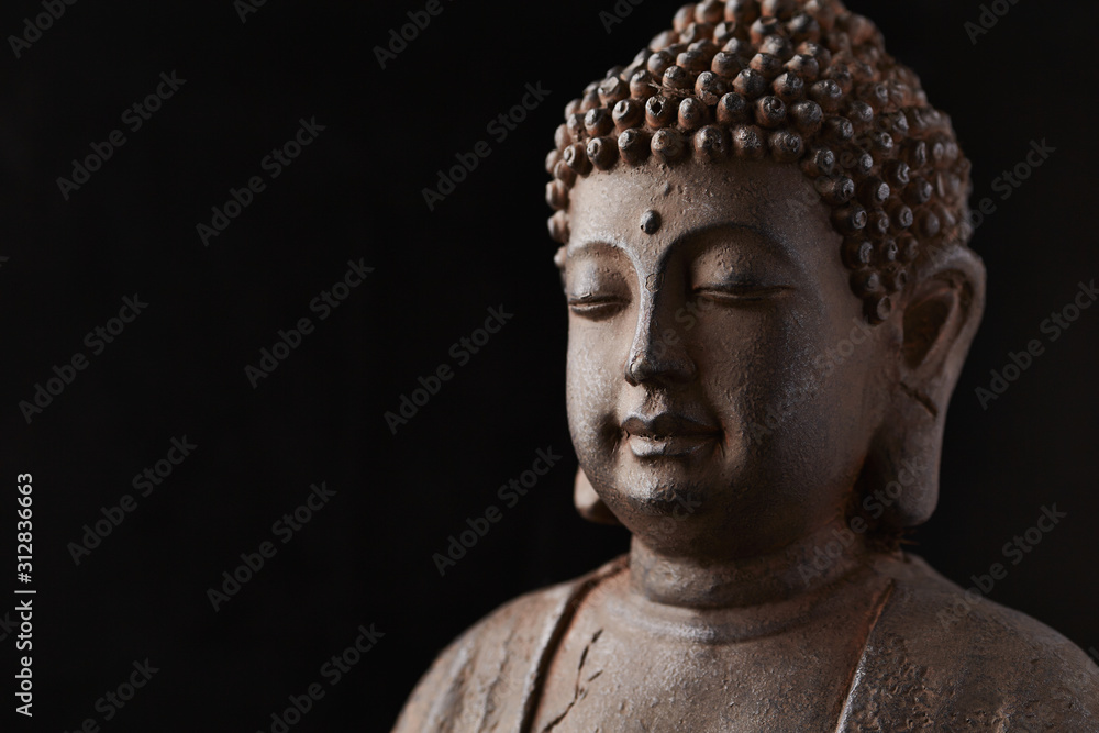 Buddha Statue (close-up). Black background.