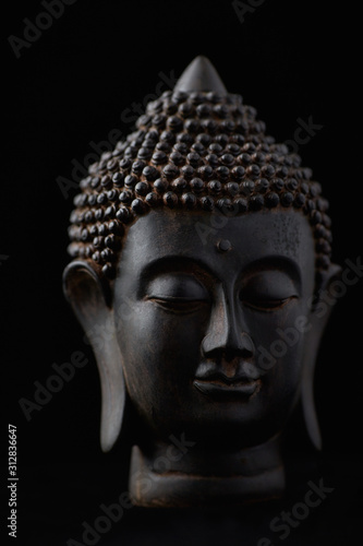 Buddha Statue (close-up). Black background. © Eugeniusz Dudziński