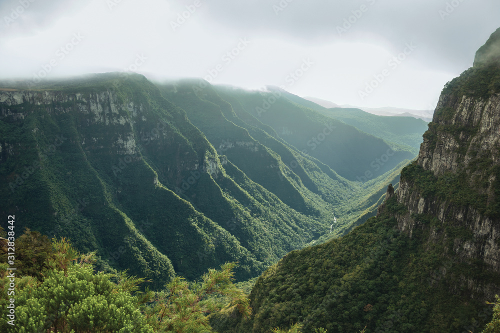 Fortaleza Canyon with rocky cliffs on foggy day