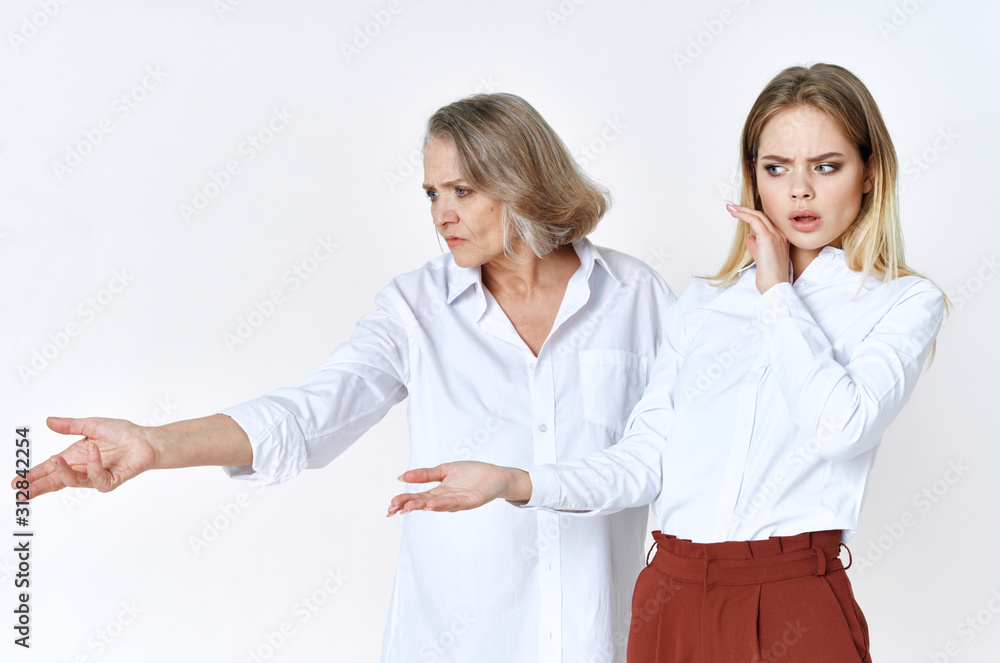 Grandmother and granddaughter are standing nearby