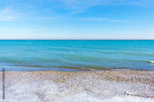 Wall Mural Beautiful turquoise colored water along Lake Michigan shoreline in winter