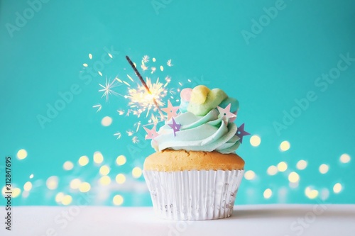 cupcake with icing and sprinkles on white background