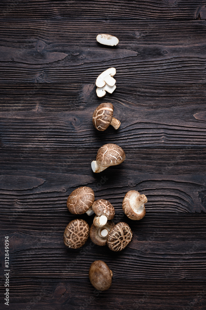 Shiitake mushrooms on the wooden background.