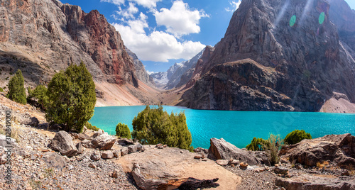 Beautiful view to mountains in Tajikistan. Fan mountains. Greater Allo lake in Fann mountains. Amazing view on mountain lakes on sunny summer day photo