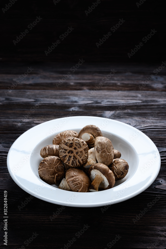 Shiitake mushrooms on the wooden background. Shiitake mushrooms on the wooden background.