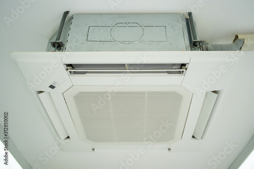 Modern ceiling air conditioner in office close up.