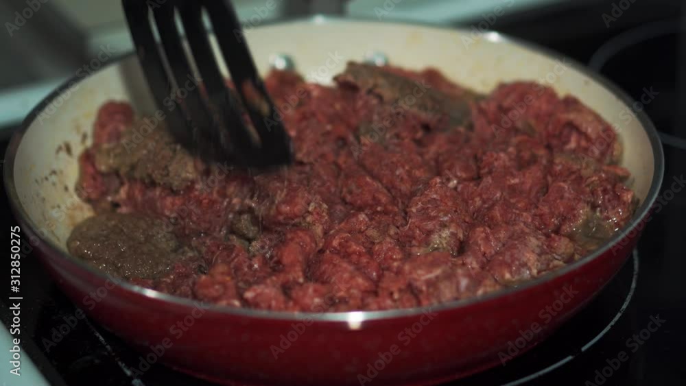 Raw and Cooked Ground Beef in Red Pan Raw and Cooked Ground Beef in Red Pan