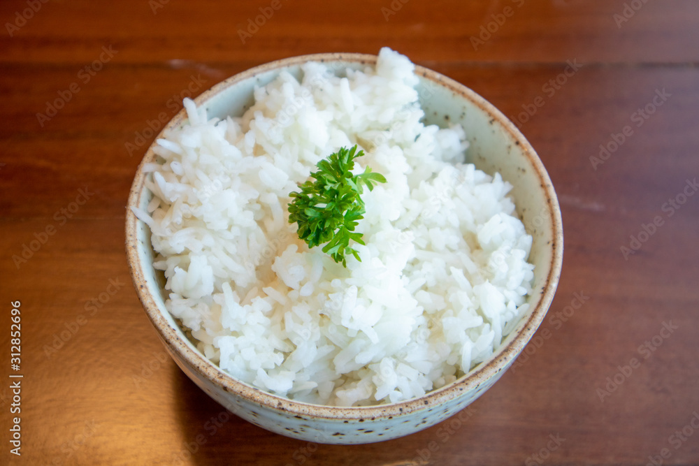 Small bowl of white rice with vegetable decorated on top. Small bowl of white rice with vegetable decorated on top.