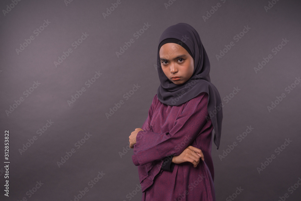 Portraiture of Muslim Girl wearing hijab.Angry face reaction. Portraiture of Muslim Girl wearing hijab.Angry face reaction.