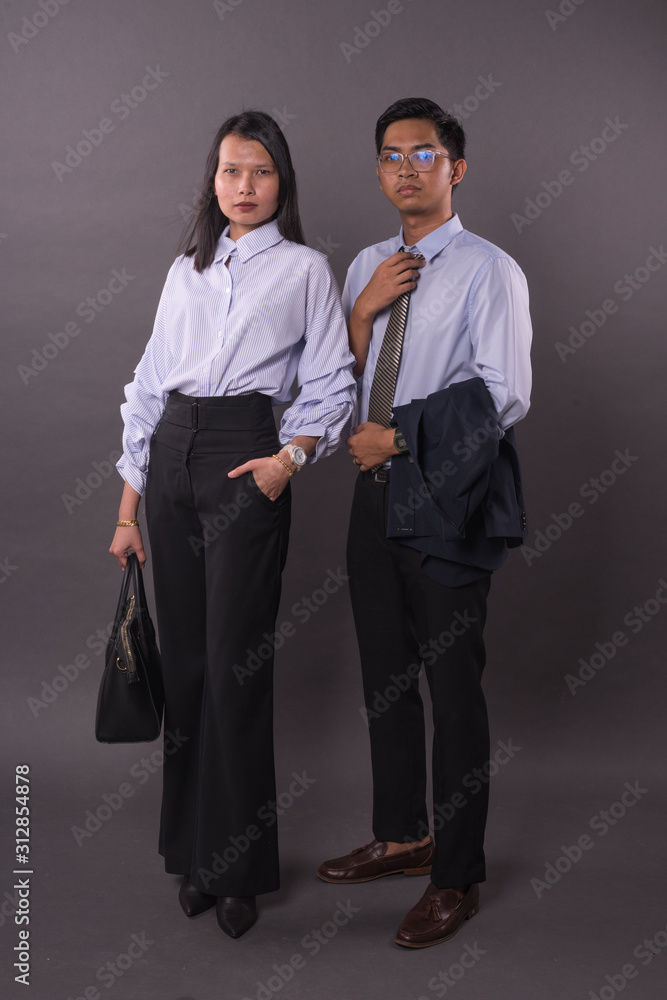 Asian business man and woman.Asian female and male model wearing office attire. Asian business man and woman.Asian female and male model wearing office attire.