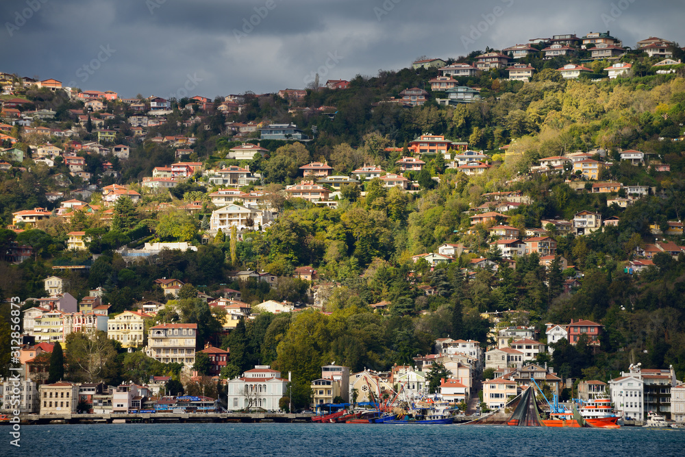Sun on the hillside of Buyukdere Turkey with Seine fishing boats on the Bosphorus Strait