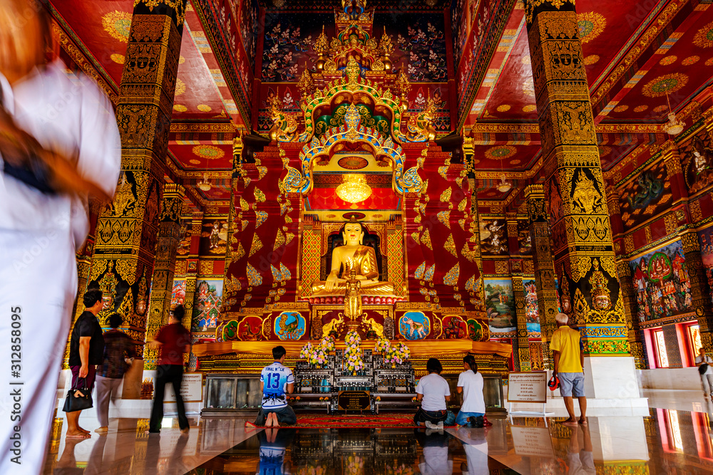 Gold buddha in temple with all people faithful