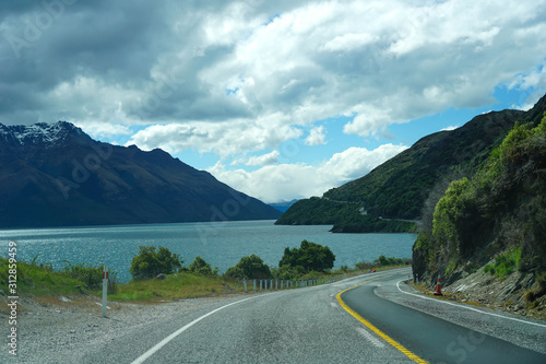 Lake, mountains, trees, sky, clouds in New Zealand.Mountain road, view from above