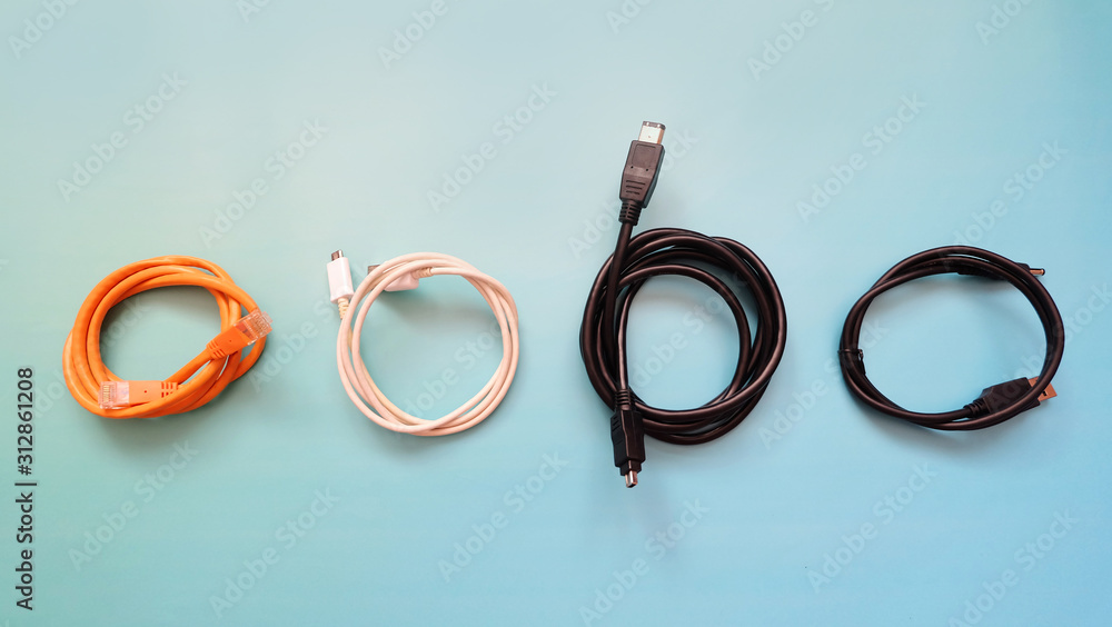 Αυτοκόλλητο Top view of 4 different types of cables rolled up neatly, arranged next to one another
