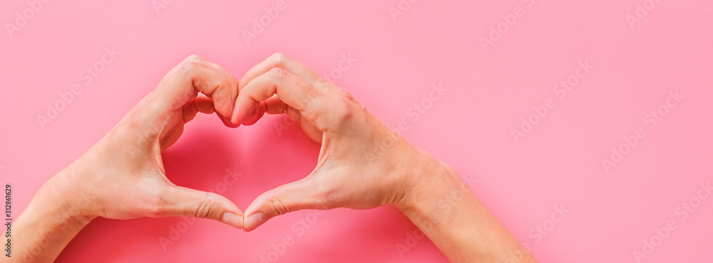 Fototapeta premium Valentine's day background. Female hands making hearth shape. Flat lay, top view, mockup, template, copy space. Minimal abstract composition for 14 February celebration