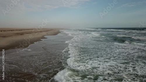 4K aerial drone video view of Namibian Atlantic coastline, Zeila L-758 Walvis Bay stranded rusty shipwreck at sand beach in Skeleton Coast Park landscape with ocean background at Namibia's west coast