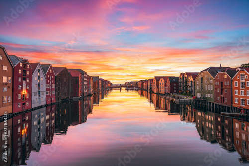Photos Colorful timber houses surrounding river Nidelva in the city of Trondheim at sunset
