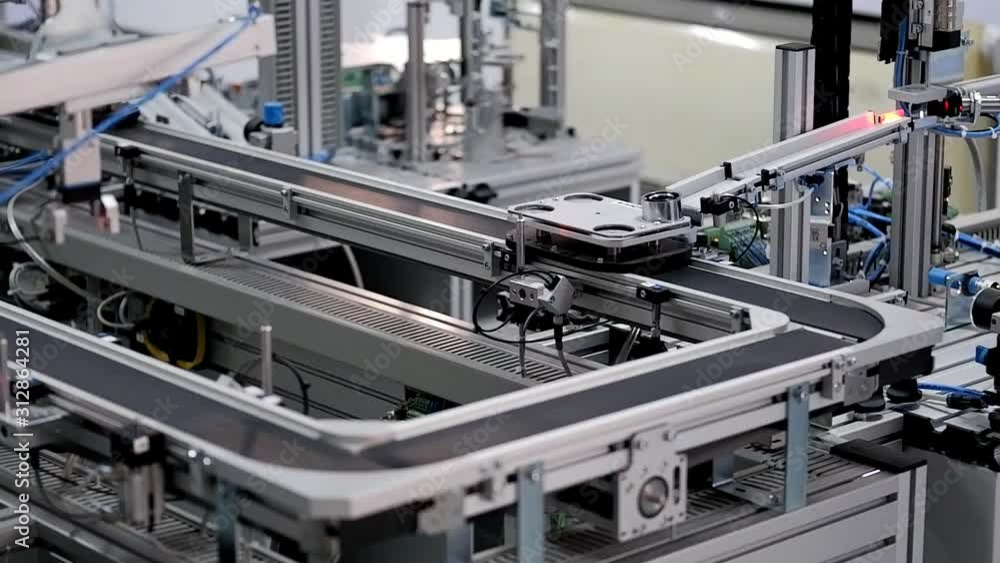 Close up of automated car is waiting to be loaded at loading station of smart factory. Industry 4.0 smart factory concept; artificial intelligence in production. Selective focus. Close up of automated car is waiting to be loaded at loading station of smart factory. Industry 4.0 smart factory concept; artificial intelligence in production. Selective focus.