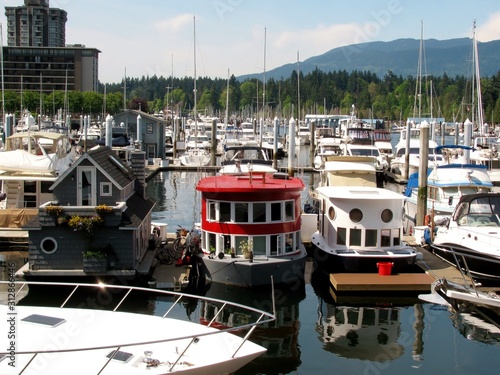 Boat houses and yachts on the water of Coal Harbour Marina. Vancouver, Canada