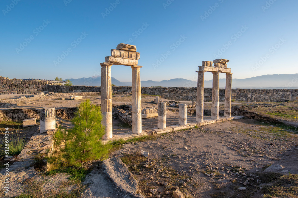 Beautiful view of the ancient ruins of the Roman city of Hierapolis in Pamukkale, Turkey. The site is a UNESCO World Heritage site near the city of Denizli. 