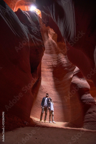 Happy couple moslem posing exploring inside the Grand Canyon, eroded sandstone rock in slot canyon, antelope valley, page, arizona, usa. 