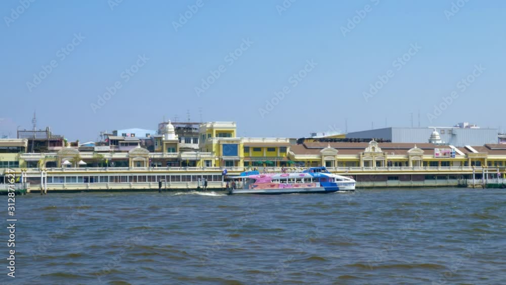 A Ferry Boat Moving With Speed over the Chao Phraya River Bangkok Thailand Wide Shot A Ferry Boat Moving With Speed over the Chao Phraya River Bangkok Thailand Wide Shot