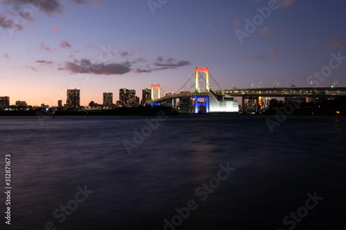 wide angle of rainbow bridge in tokyo at sunset. long exposure