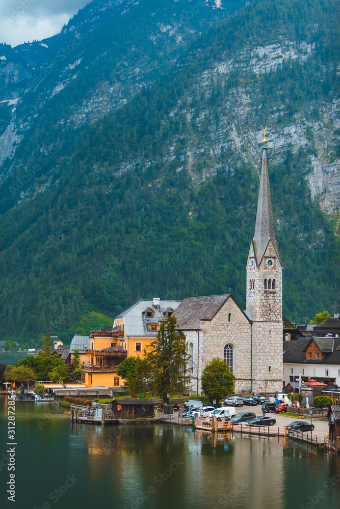 Evangelical hallstatt church at lake shore alps mountains on background